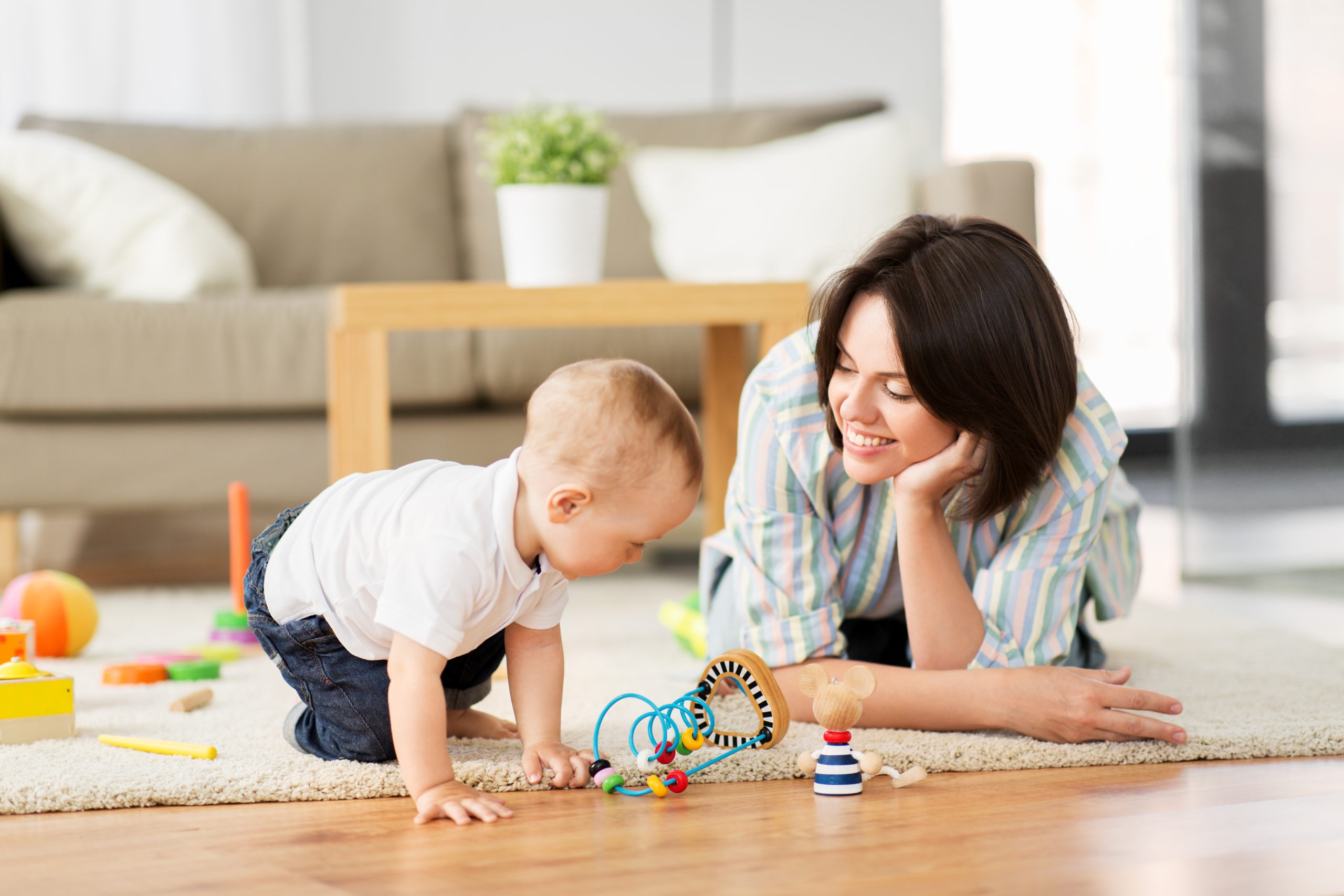 happy mother with little baby son playing at home family, child and motherhood concept - happy mother with little baby son playing developmental toys at home
